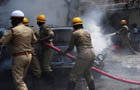 Chaotic scenes at blast site, vehicles in flames